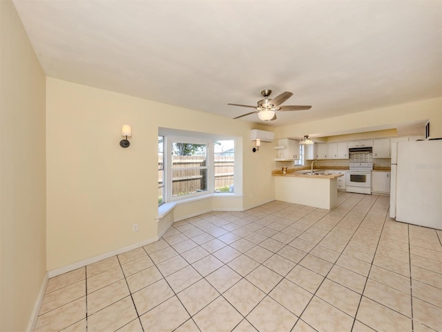 200 Sierra St S, Nokomis, FL 34275 - kitchen featuring a ceiling fan, a peninsula, light tile patterned floors, and white appliances
