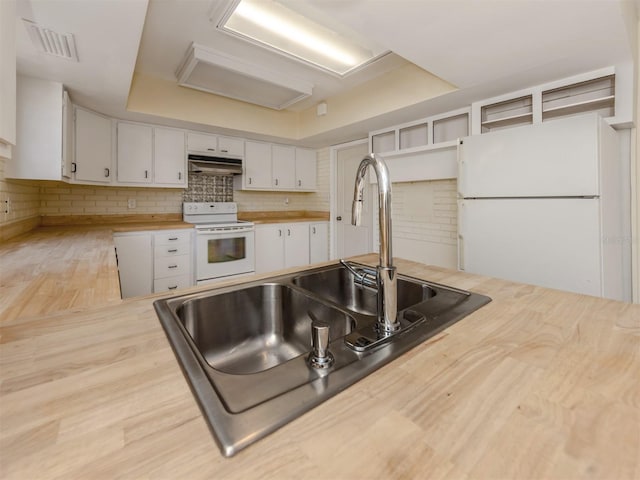 200 Sierra St S, Nokomis, FL 34275 - kitchen featuring white appliances, butcher block countertops, under cabinet range hood, a sink, and visible vents