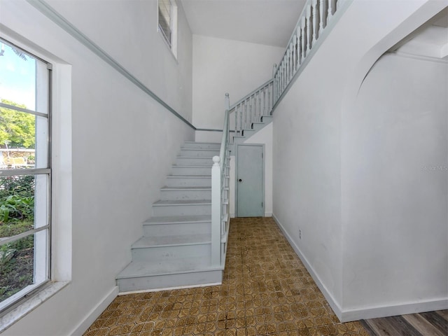 200 Sierra St S, Nokomis, FL 34275 - stairs with baseboards, a towering ceiling, and tile patterned floors