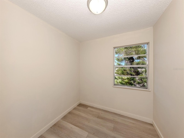200 Sierra St S, Nokomis, FL 34275 - spare room featuring baseboards, a textured ceiling, and light wood-style floors