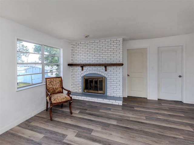 200 Sierra St S, Nokomis, FL 34275 - living area featuring baseboards, a fireplace, and wood finished floors