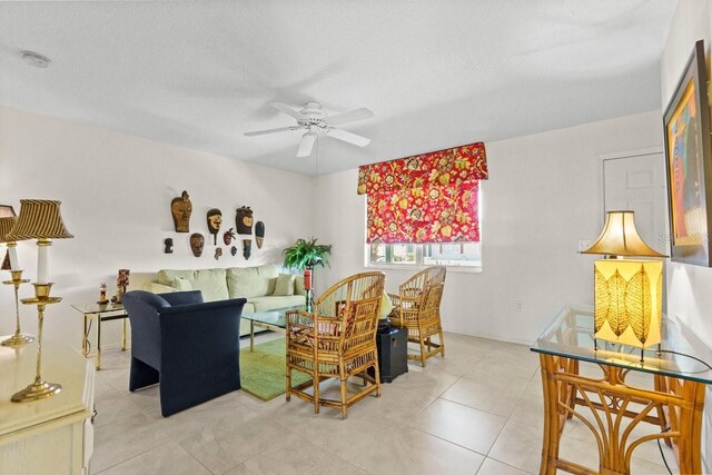888 Kimball Rd, Venice, FL 34293 - living area with a textured ceiling, light tile patterned floors, and a ceiling fan
