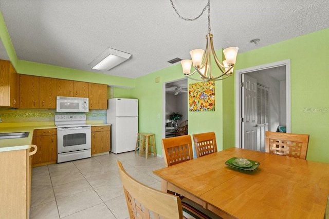 888 Kimball Rd, Venice, FL 34293 - dining area with a textured ceiling, visible vents, an inviting chandelier, and light tile patterned floors