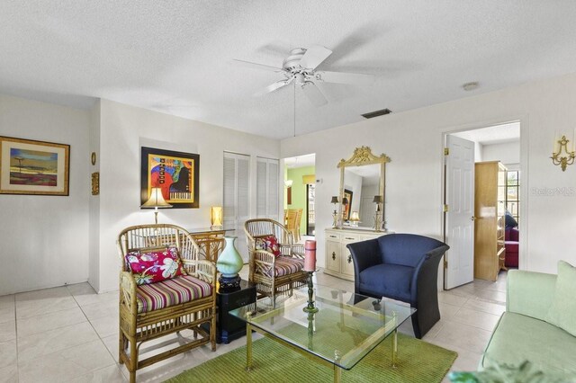 888 Kimball Rd, Venice, FL 34293 - living area with light tile patterned flooring, a textured ceiling, visible vents, and a ceiling fan