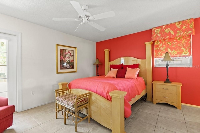 888 Kimball Rd, Venice, FL 34293 - bedroom with tile patterned flooring, baseboards, ceiling fan, and a textured ceiling