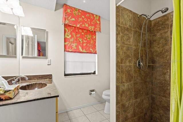 888 Kimball Rd, Venice, FL 34293 - full bathroom featuring baseboards, toilet, a tile shower, vanity, and tile patterned flooring