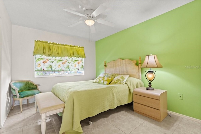888 Kimball Rd, Venice, FL 34293 - bedroom with baseboards, light tile patterned flooring, and a ceiling fan