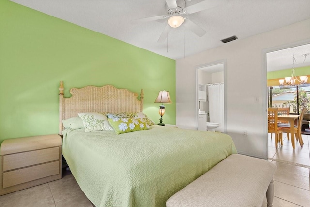 888 Kimball Rd, Venice, FL 34293 - bedroom with tile patterned floors, visible vents, ceiling fan with notable chandelier, and ensuite bathroom
