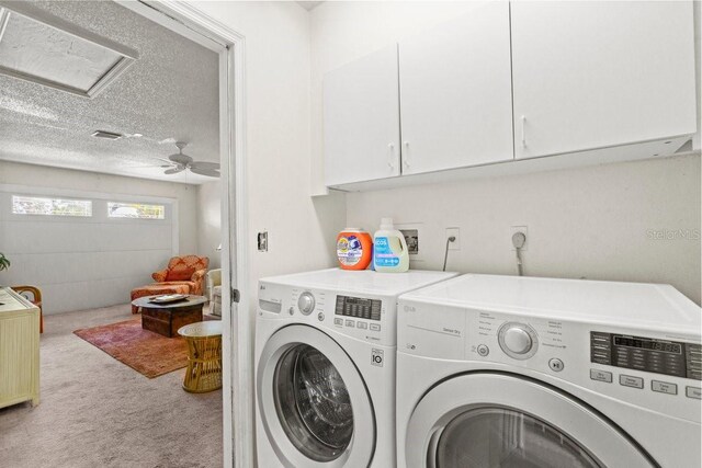 888 Kimball Rd, Venice, FL 34293 - washroom with carpet flooring, attic access, separate washer and dryer, a textured ceiling, and cabinet space