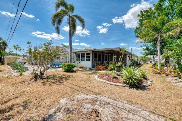 rear view of house featuring a sunroom