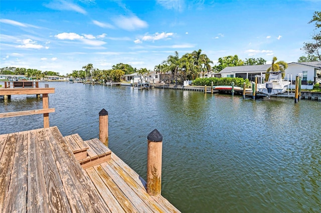 dock area with a residential view and a water view