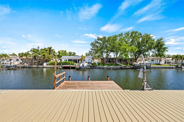 dock area featuring a water view and a residential view