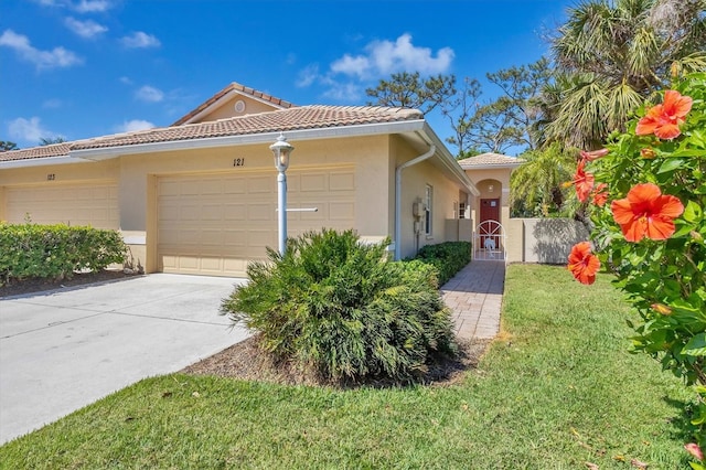 121 Auburn Woods Cir, Venice, FL 34292 - mediterranean / spanish home with a garage, concrete driveway, a front yard, a tile roof, and stucco siding
