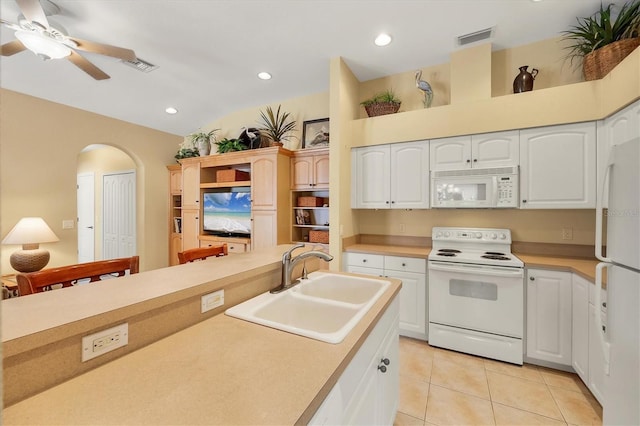 121 Auburn Woods Cir, Venice, FL 34292 - kitchen featuring a sink, arched walkways, visible vents, and white appliances
