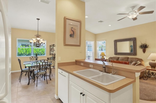 121 Auburn Woods Cir, Venice, FL 34292 - kitchen with open floor plan, ceiling fan with notable chandelier, a sink, white cabinets, and white dishwasher