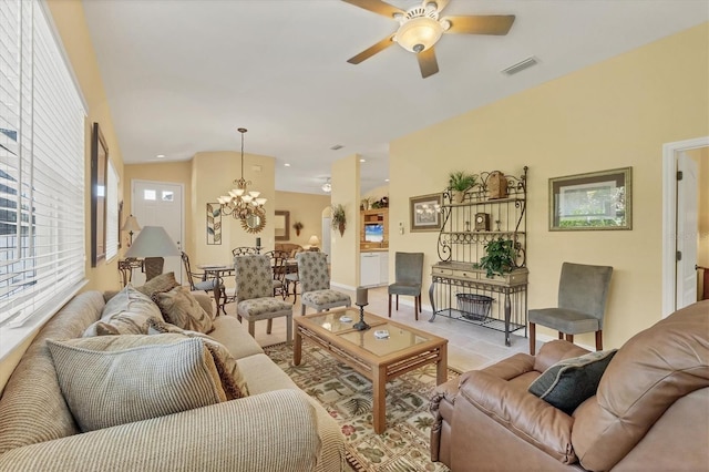 121 Auburn Woods Cir, Venice, FL 34292 - living room featuring light tile patterned floors, ceiling fan with notable chandelier, and visible vents