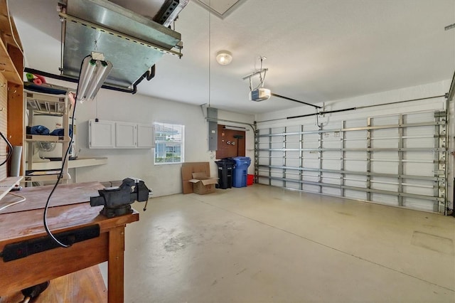 121 Auburn Woods Cir, Venice, FL 34292 - garage featuring electric panel and a garage door opener