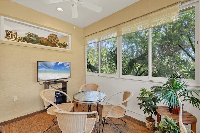 121 Auburn Woods Cir, Venice, FL 34292 - sunroom / solarium featuring a wealth of natural light, a textured wall, baseboards, and wood finished floors