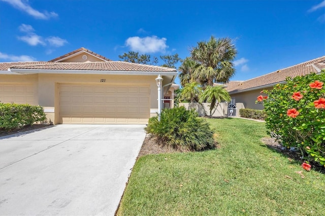 121 Auburn Woods Cir, Venice, FL 34292 - view of front of house with stucco siding, an attached garage, a front lawn, and concrete driveway