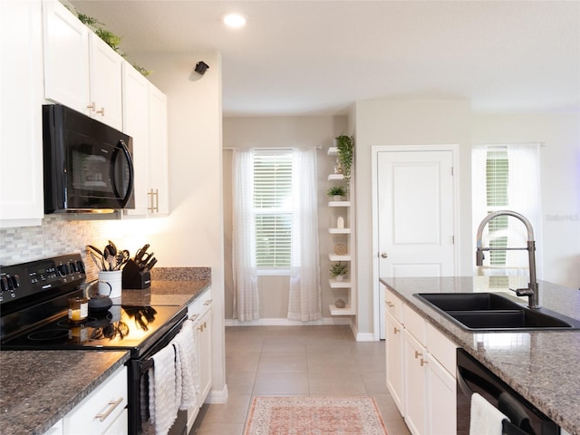 4907 Wedgeleaf Way, Palmetto, FL 34221 - kitchen with stone countertops, a sink, white cabinets, and black appliances