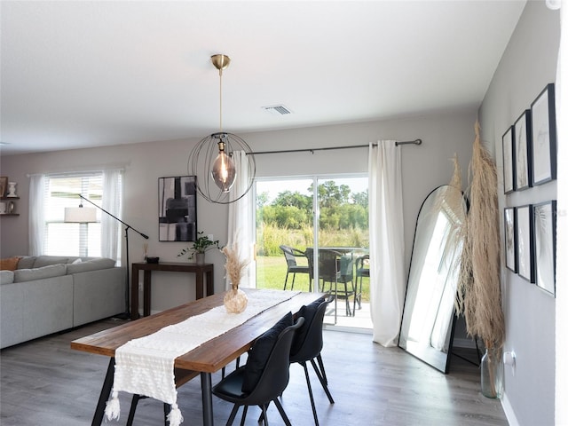 4907 Wedgeleaf Way, Palmetto, FL 34221 - dining space featuring visible vents and wood finished floors