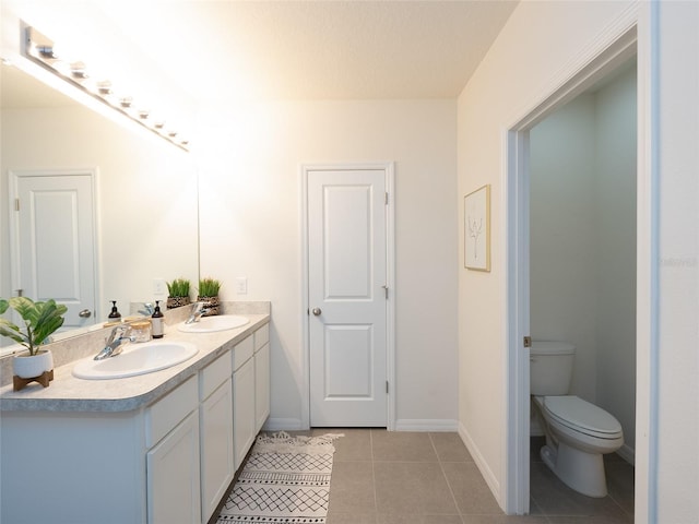 4907 Wedgeleaf Way, Palmetto, FL 34221 - bathroom featuring double vanity, a sink, tile patterned floors, and toilet