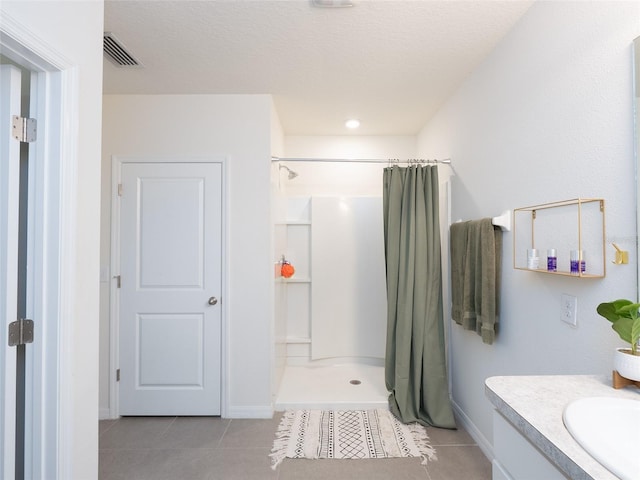 4907 Wedgeleaf Way, Palmetto, FL 34221 - bathroom with visible vents, tile patterned flooring, vanity, baseboards, and a shower with shower curtain