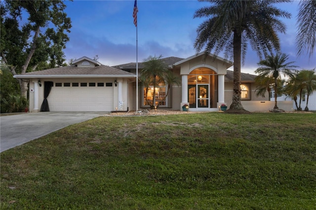4305 Sandune Ave, North Port, FL 34287 - ranch-style house with stucco siding, concrete driveway, a garage, and a front yard