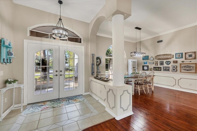 4305 Sandune Ave, North Port, FL 34287 - entryway with arched walkways, healthy amount of natural light, french doors, ornamental molding, and wood finished floors