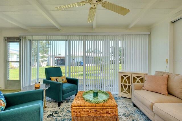 sunroom featuring beam ceiling and plenty of natural light