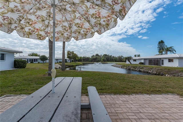 view of community with a water view and a yard