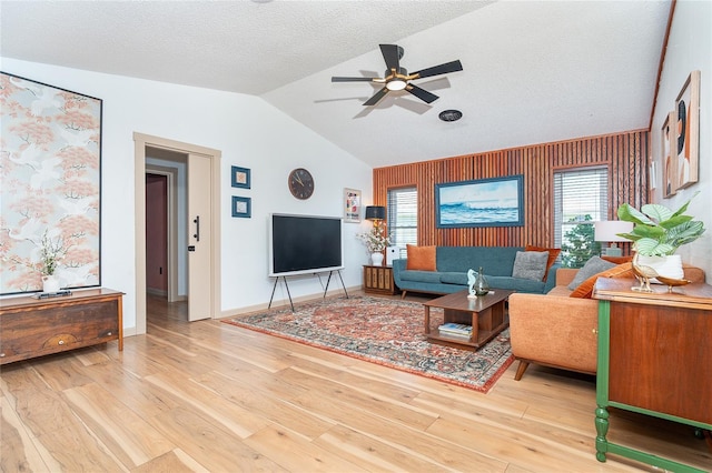 23 Tiffany St, Englewood, FL 34223 - living area featuring ceiling fan, lofted ceiling, wood finished floors, plenty of natural light, and baseboards