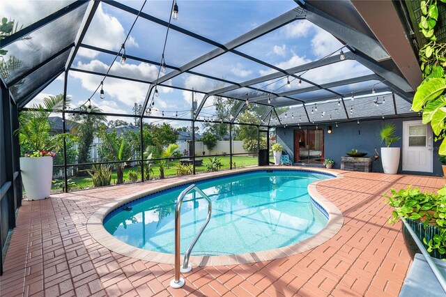 23 Tiffany St, Englewood, FL 34223 - outdoor pool featuring a patio area and glass enclosure