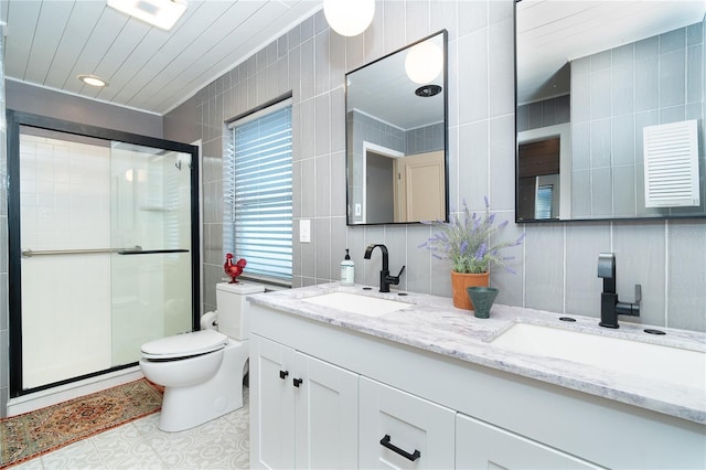 23 Tiffany St, Englewood, FL 34223 - full bathroom featuring tile walls, double vanity, toilet, and a shower stall