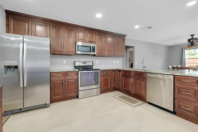 4068 Palau Dr, Sarasota, FL 34241 - kitchen featuring appliances with stainless steel finishes, ceiling fan, recessed lighting, and light stone countertops