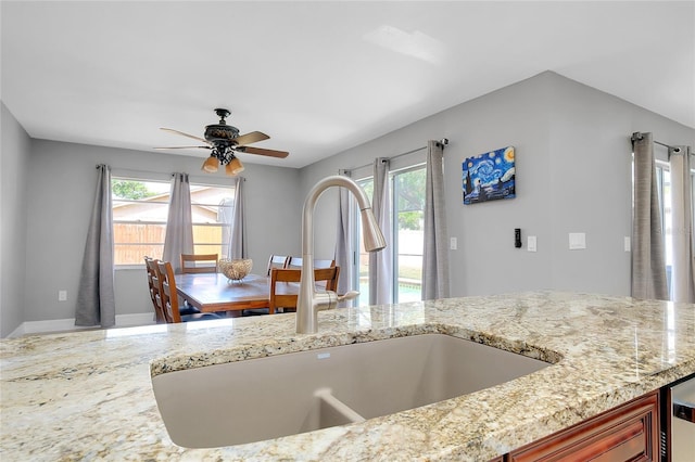 4068 Palau Dr, Sarasota, FL 34241 - kitchen featuring a ceiling fan and light stone countertops