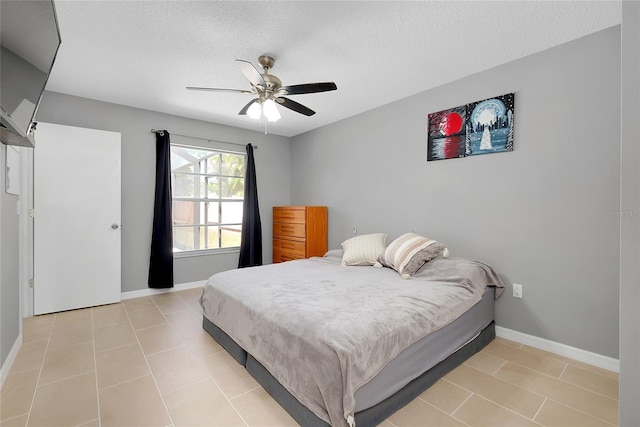 4068 Palau Dr, Sarasota, FL 34241 - bedroom with a textured ceiling, light tile patterned floors, and a ceiling fan