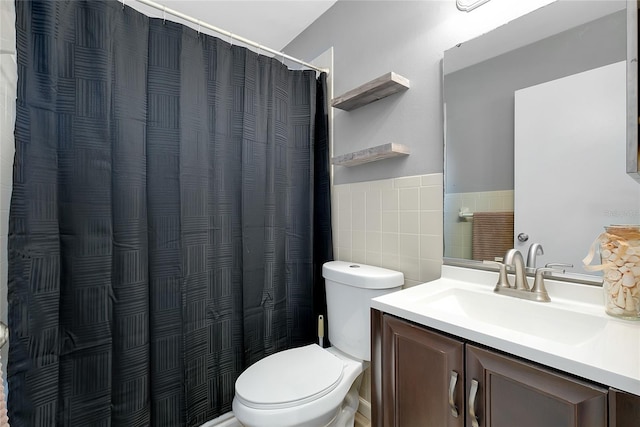 4068 Palau Dr, Sarasota, FL 34241 - full bathroom with tile walls, vanity, wainscoting, and curtained shower