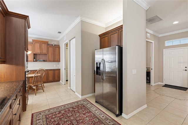 1625 Lancashire Dr, Venice, FL 34293 - kitchen with baseboards, ornamental molding, light tile patterned flooring, visible vents, and appliances with stainless steel finishes