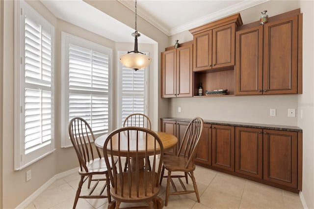 1625 Lancashire Dr, Venice, FL 34293 - dining area with light tile patterned floors, baseboards, and crown molding