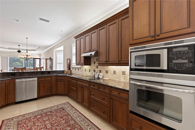 1625 Lancashire Dr, Venice, FL 34293 - kitchen featuring under cabinet range hood, light tile patterned floors, visible vents, and appliances with stainless steel finishes