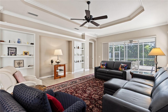 1625 Lancashire Dr, Venice, FL 34293 - living room with built in features, light tile patterned floors, ceiling fan, a tray ceiling, and visible vents