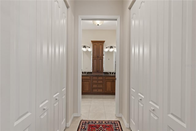 1625 Lancashire Dr, Venice, FL 34293 - corridor featuring light tile patterned floors and a sink