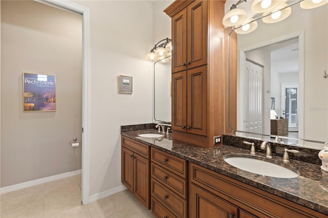 1625 Lancashire Dr, Venice, FL 34293 - full bathroom featuring tile patterned flooring, double vanity, baseboards, and a sink