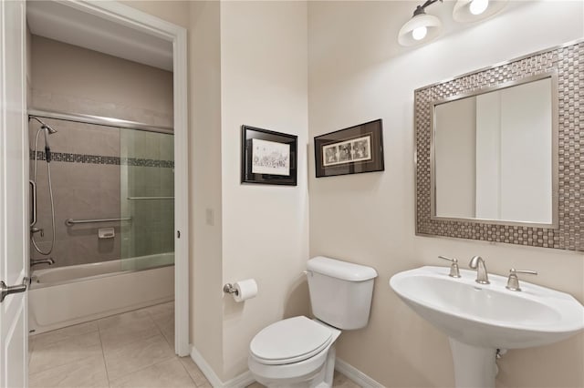 1625 Lancashire Dr, Venice, FL 34293 - bathroom featuring toilet, tile patterned floors, a sink, and baseboards