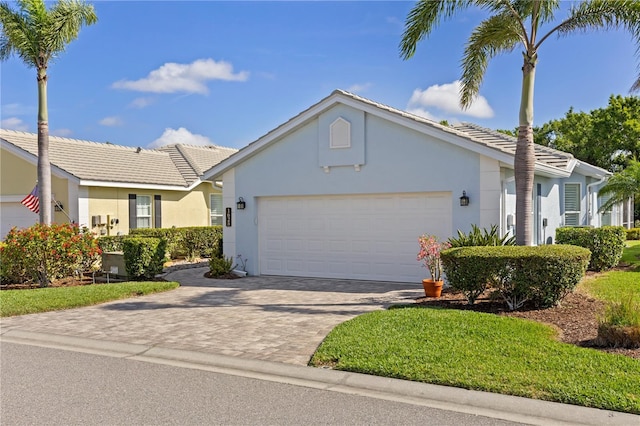 1625 Lancashire Dr, Venice, FL 34293 - single story home featuring stucco siding, decorative driveway, an attached garage, and a tile roof