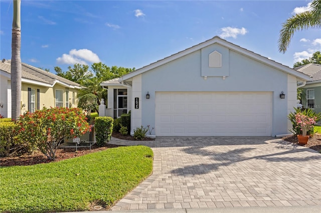 1625 Lancashire Dr, Venice, FL 34293 - ranch-style house with a garage, stucco siding, and decorative driveway