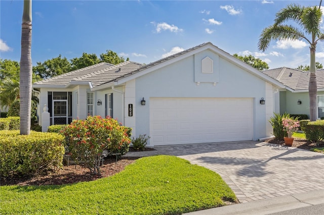 1625 Lancashire Dr, Venice, FL 34293 - single story home featuring a tiled roof, driveway, a garage, and stucco siding