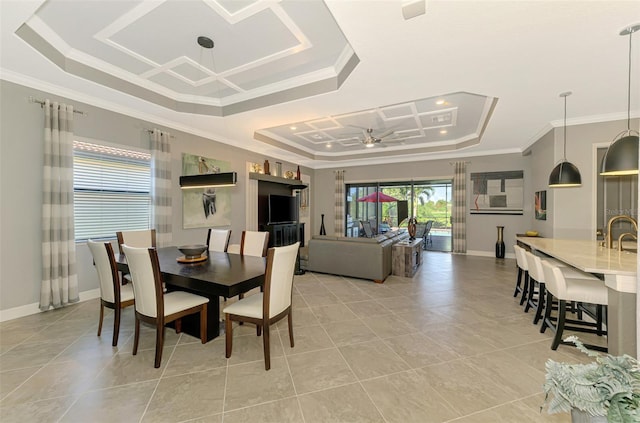 24193 Gallberry Dr, Venice, FL 34293 - dining space featuring a raised ceiling, crown molding, and light tile patterned flooring