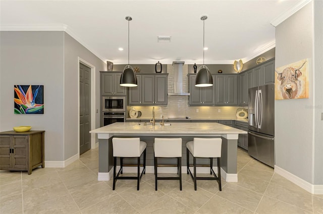 24193 Gallberry Dr, Venice, FL 34293 - kitchen with crown molding, wall chimney range hood, gray cabinets, appliances with stainless steel finishes, and decorative backsplash